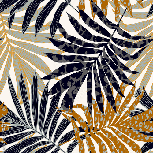 Abstract palm leaves filled with animal print. Modern trendy tropical seamles...