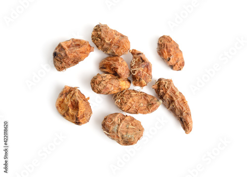 Dried tubers Cyperus esculentus also called chufa, tiger nut, atadwe, yellow nutsedge, and earth almond. Isolated photo