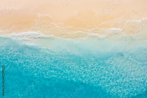 Summer seascape beautiful waves  blue sea water in sunny day. Top view from drone. Sea aerial view  amazing tropical nature background. Beautiful bright sea with waves splashing and beach sand concept