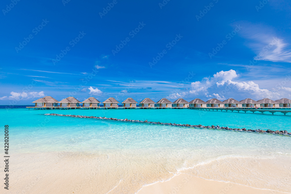 Fototapeta premium Ocean lagoon bay view, blue sky and clouds with wooden jetty and over water bungalows, villas, endless horizon. Meditation relaxation tropical background, sea ocean water. Skyscape seascape background
