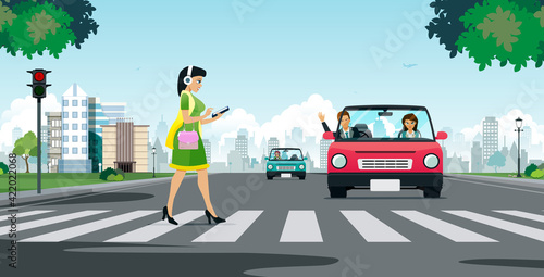 A woman looking at a smartphone while crossing a crosswalk.