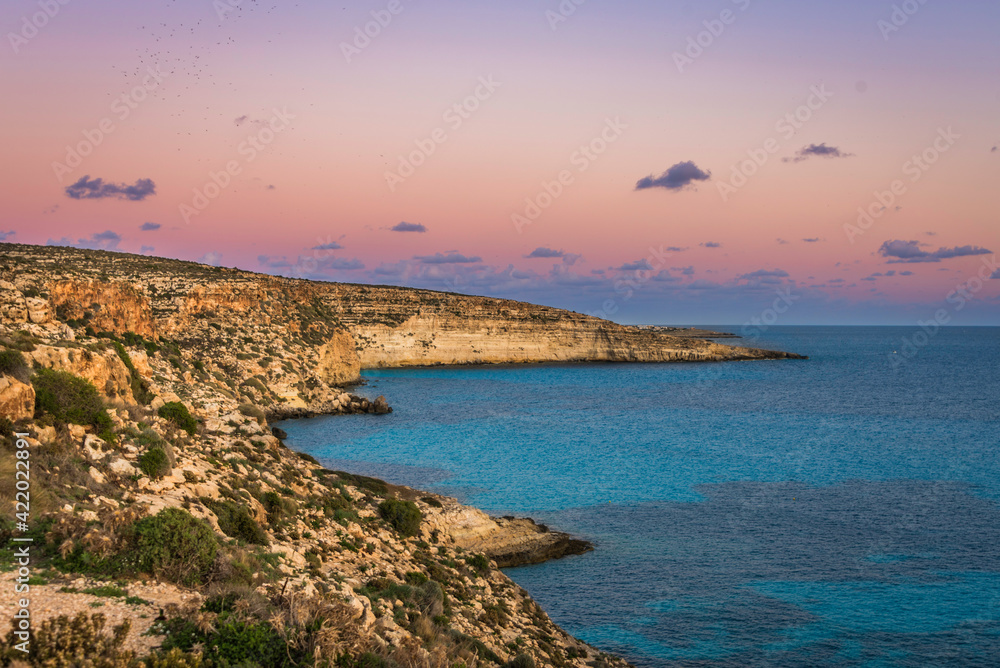 Pastel sunset sky over the Rabbit Beach in Lampedusa, Sicily