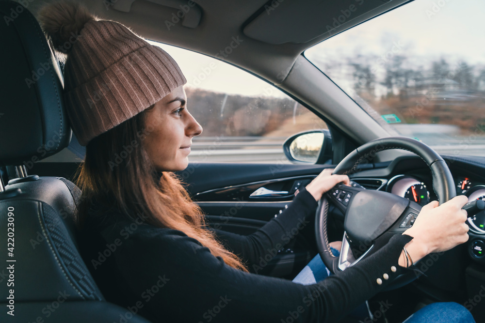Woman driving car on highway leaving city for holidays. Vaccine passport Woman driving car on highway leaving city for holidays. Vaccine passport