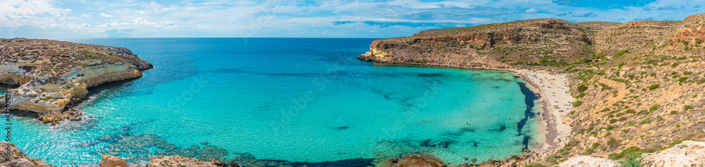 Pano pf The Rabbit beach in Lampedusa, Pelagie islands. A wild beach, protected by WWF , for being home of the extinct loggerhead turtles, who lay theirs eggs in the area Pano pf The Rabbit beach in Lampedusa, Pelagie islands. A wild beach, protected by WWF , for being home of the extinct loggerhead turtles, who lay theirs eggs in the area