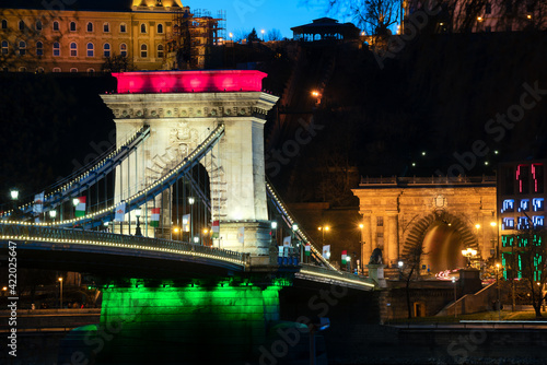 The famous Chain bridge in Budapest festive illuminated with national flag colours due national celebrate day. Zhis day is march 15. the memorial day od 1848-48 revolutional liberty war photo