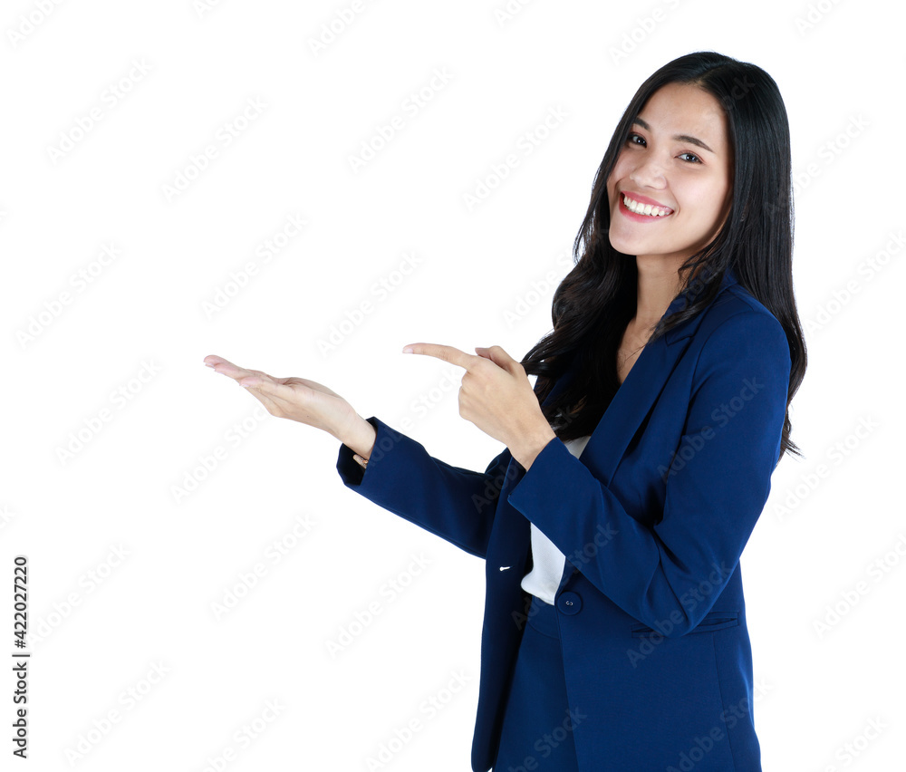 Portrait studio shot of a young friendly face and beautiful Asian woman in dark blue office business suit standing with friendly smile face and pose to camera and pointing finger to blank space Portrait studio shot of a young friendly face and beautiful Asian woman in dark blue office business suit standing with friendly smile face and pose to camera and pointing finger to blank space