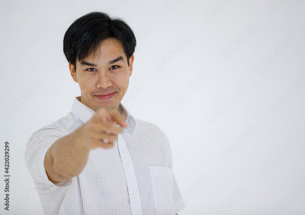 Portrait of Asian young and handsome businessman in casual shirt and slack trousers posing in advertising gesture pointing finger to camera isolated on white background. Portrait of Asian young and handsome businessman in casual shirt and slack trousers posing in advertising gesture pointing finger to camera isolated on white background.