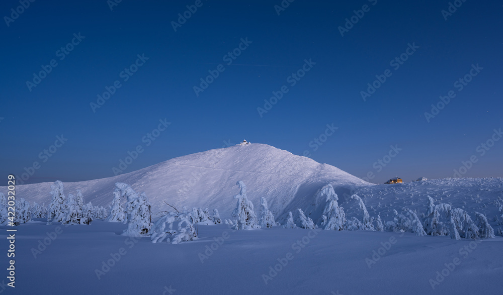 amazing view of Sniezka peak at dusk in winter in the Karkonosze Mountains in Poland