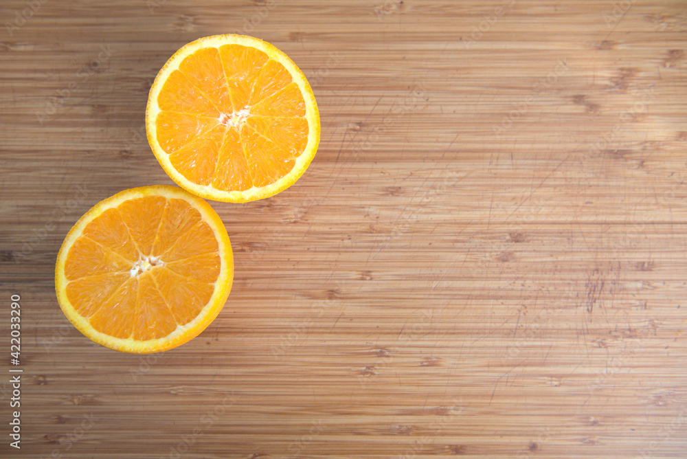 Cut orange on a bamboo board Cut orange on a bamboo board