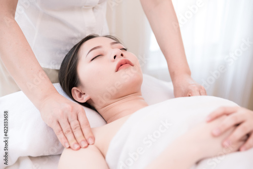 Young Asian woman getting Body massage, Relaxing oil massage at beauty spa salon. Massage for health