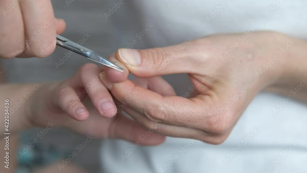 Child's fingernails. Mom cuts the child's long fingernails. Child's fingernails. Mom cuts the child's long fingernails.