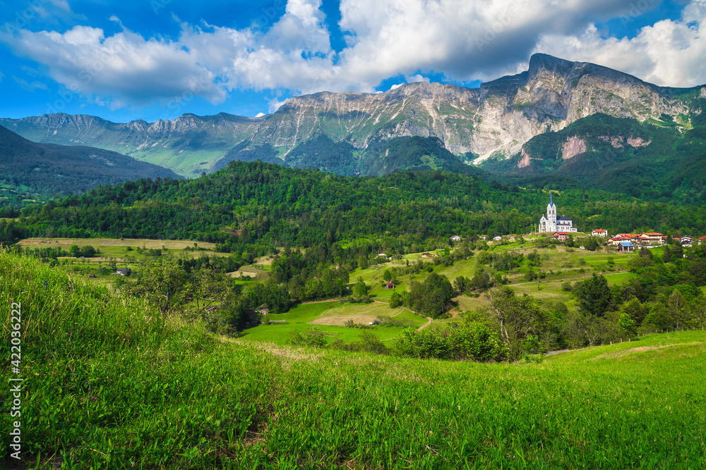 Fototapeta premium Wonderful alpine scenery and Dreznica mountain village with church, Slovenia