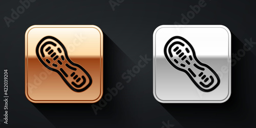 Gold and silver Human footprints shoes icon isolated on black background. Shoes sole. Long shadow style. Vector