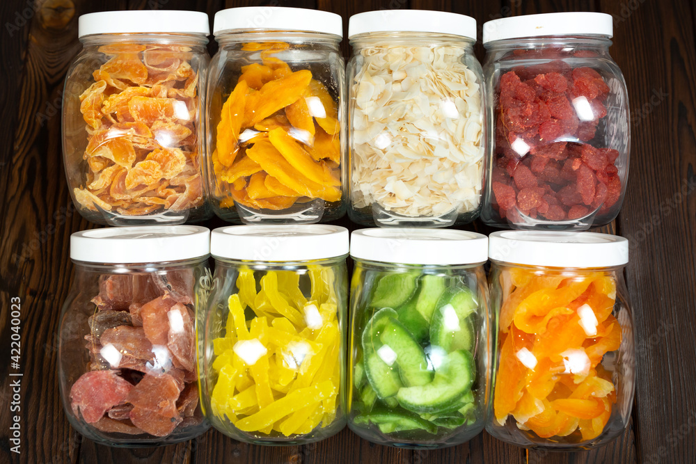 The concept of food, storage and nutrition - close-up of cans of dried fruit on a wooden background in a grocery store. The concept of food, storage and nutrition - close-up of cans of dried fruit on a wooden background in a grocery store.
