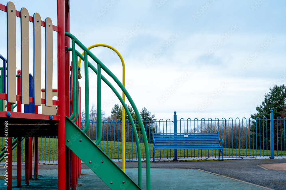 Public colouful modern playground in the park in gloomy day spring, Outdoor playground equipment for children Public colouful modern playground in the park in gloomy day spring, Outdoor playground equipment for children