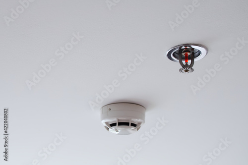 Smoke detectors sensor and water sprinkler, Automatic fire extinguishing systems, Installed inside the buildings to prevent fire for safety of life and property, On white background with copy space.