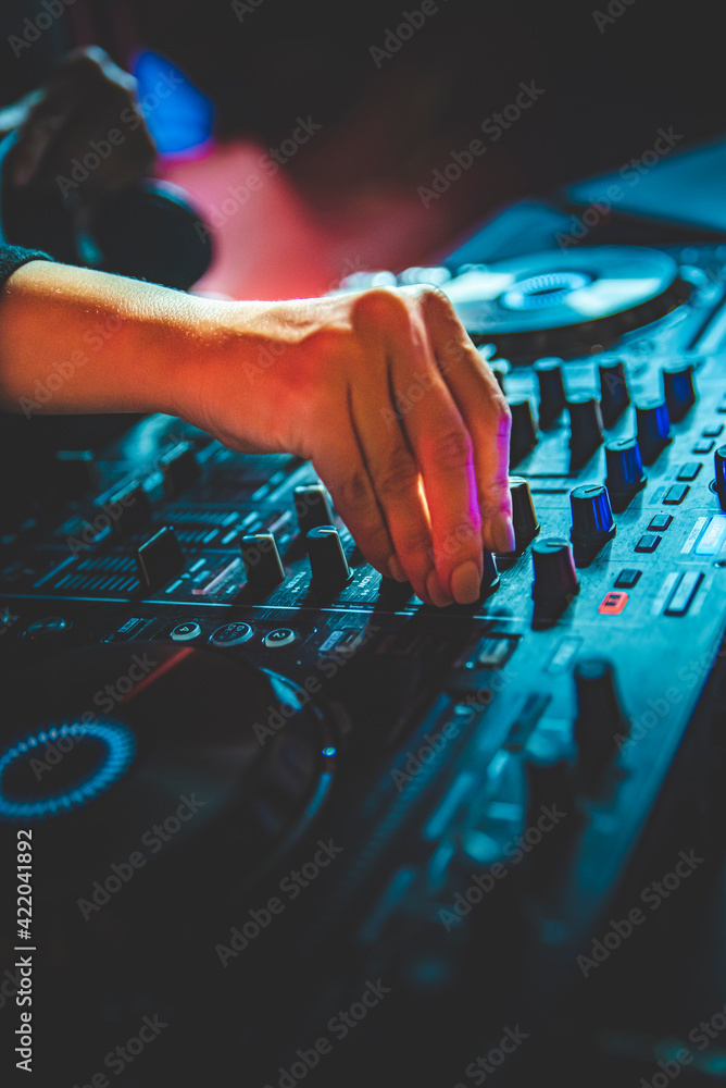 DJ Hands creating and regulating music on dj console mixer in concert nightclub stage DJ Hands creating and regulating music on dj console mixer in concert nightclub stage
