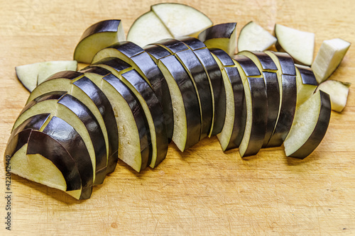 slices of eggplant on a wooden cutting board