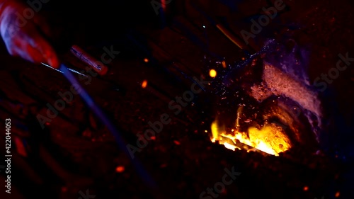 blacksmith. Blacksmithing Workshop.Metalworking.  Blacksmith is using hammer to forge metal