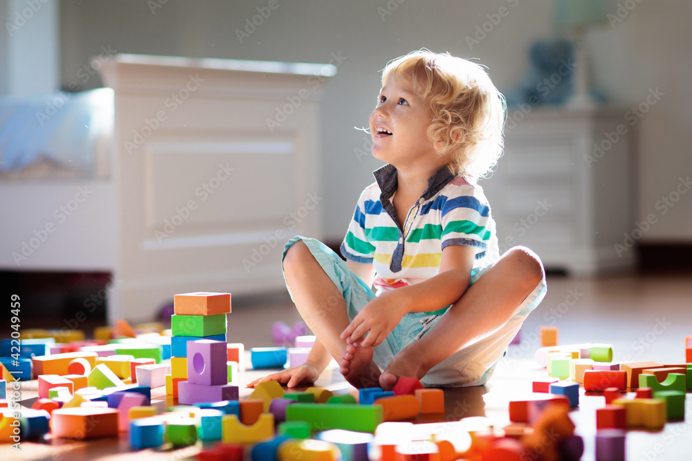 Child playing with colorful toy blocks. Kids play. Child playing with colorful toy blocks. Kids play.