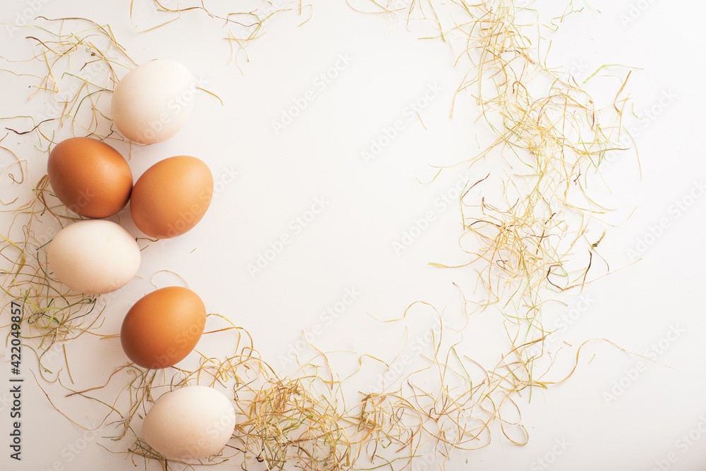 Easter frame in the form of a wreath of dry grass and eggs. Easter concept. Easter card with place for text. Easter frame in the form of a wreath of dry grass and eggs. Easter concept. Easter card with place for text.