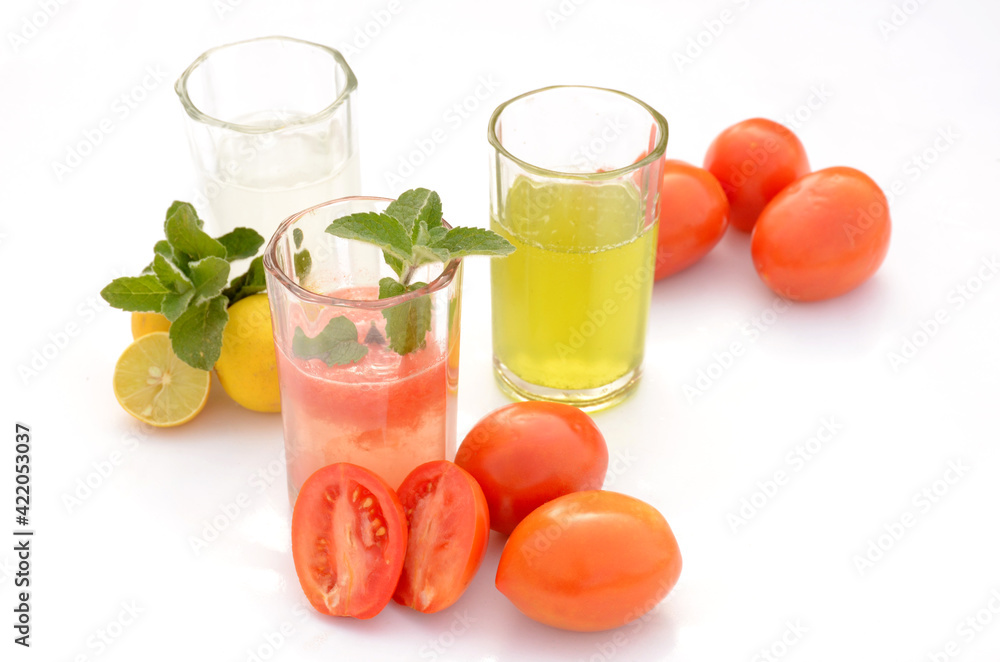 the healthy food tomato ,lemon,mint,juice with tomato ,lemon,and mint plant isolated on white background. the healthy food tomato ,lemon,mint,juice with tomato ,lemon,and mint plant isolated on white background.