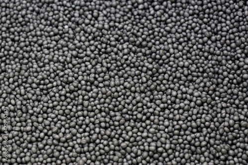 Macro image of graphite microbead pearls used for house insulation by injecting into the cavity walls  photo