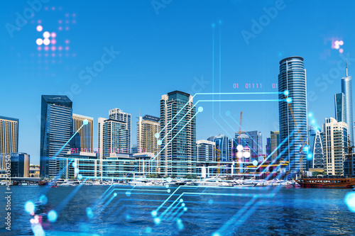 Skyscrapers of Dubai business downtown. International hub of trading and financial services. Technology theme icons hologram  concept of big data. Double exposure. Dubai Canal waterfront.