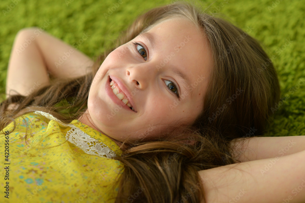 Portrait of beautiful teen girl lying on floor in room Portrait of beautiful teen girl lying on floor in room