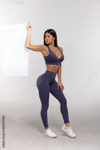 girl in purple leggings and top on a white background