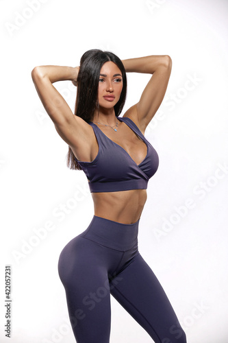 girl in purple leggings and top on a white background © Vitalii But