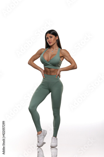 girl in olive leggings and top on a white background