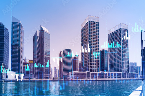 Skyscrapers of Dubai business downtown. International hub of trading and financial services of Western Asia. FOREX graph and chart concept. Double exposure. Dubai Canal waterfront. © VideoFlow