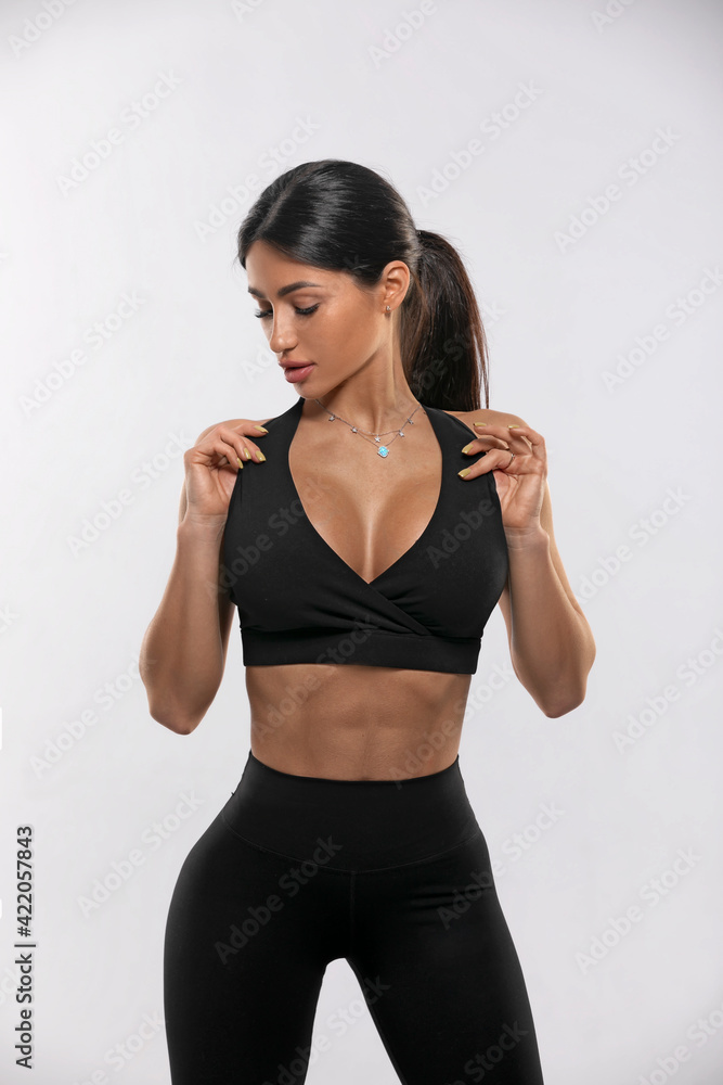 girl in black leggings and a top on a white background girl in black leggings and a top on a white background