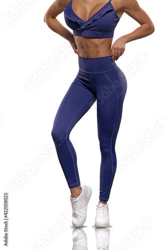 legs girl in blue leggings and top on a white background