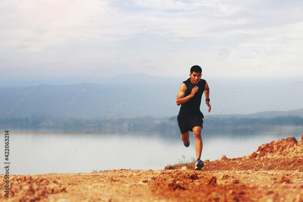 A young man jogging with a strong and agile posture.