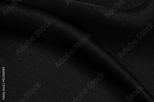 Smooth elegant black silk or satin texture can use as abstract background