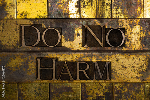 Do No Harm letter art on vintage textured grunge copper and gold steampunk background