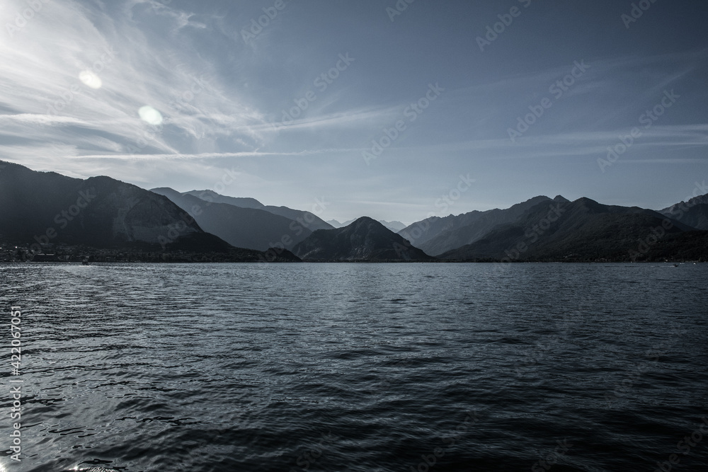 Majestic peaks rise above the vast expanses of Lake Maggiore in Italy. The contour lighting creates a halftone perspective.