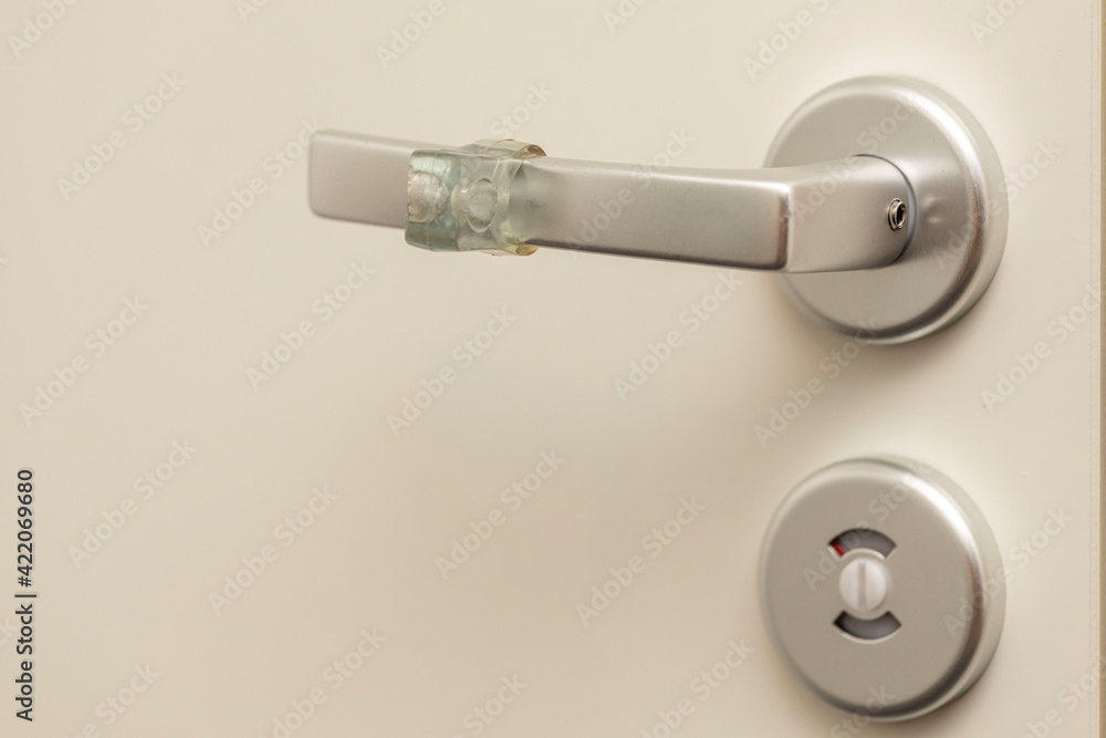 Close up view of lock and handle buffer rubber on white door. Interior design. Beautiful backgrounds. Close up view of lock and handle buffer rubber on white door. Interior design. Beautiful backgrounds.
