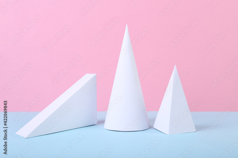 White geometric figures on a blue-pink pastel background. Composition of different geometric objects. Concept art. Abstract background, minimalism White geometric figures on a blue-pink pastel background. Composition of different geometric objects. Concept art. Abstract background, minimalism