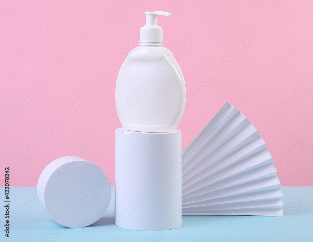 Beauty still life. Product presentation. Cream bottle and geometric shapes on a blue-pink pastel background. Minimalism, Concept art Beauty still life. Product presentation. Cream bottle and geometric shapes on a blue-pink pastel background. Minimalism, Concept art