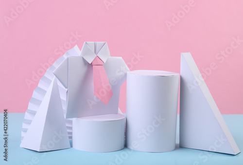 Origami shirt and Basic geometric shapes composition on pink blue pastel background. Business concept. Concept art. Minimalism