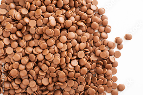 Chocolate callets background. The concept of tempered chocolate confectionery. Cooking chocolates by homemade confectioners. Business idea. close-up and flat lay