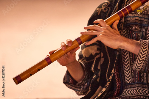 Close-up of a street musician playing Bansuri Indian Flute