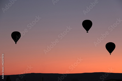 silhouette of hot air balloons against amazing sky