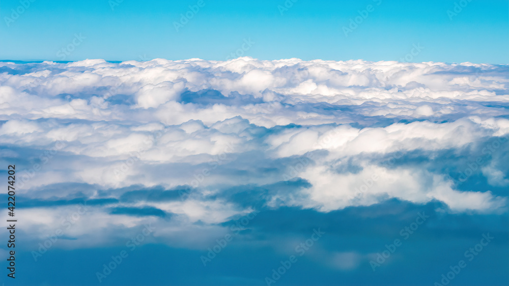 Beautiful cloud patterns are seen from a commercial airplane