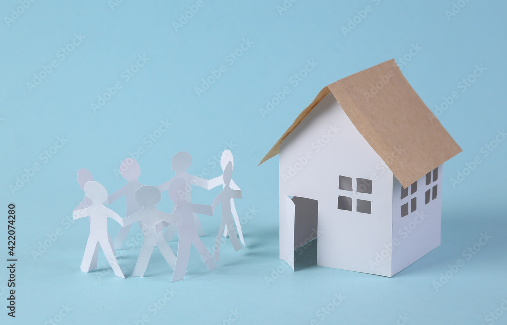 Chain of paper-cut people and house figurine. Unity, family concept Chain of paper-cut people and house figurine. Unity, family concept