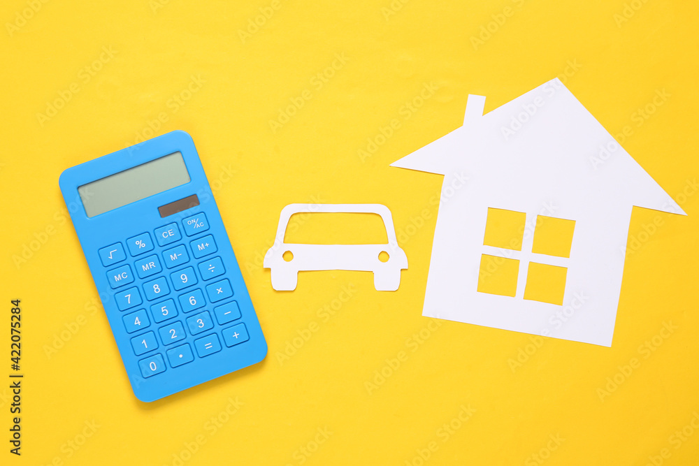Calculator, Paper-cut house and car on yellow background. Property insurance Calculator, Paper-cut house and car on yellow background. Property insurance
