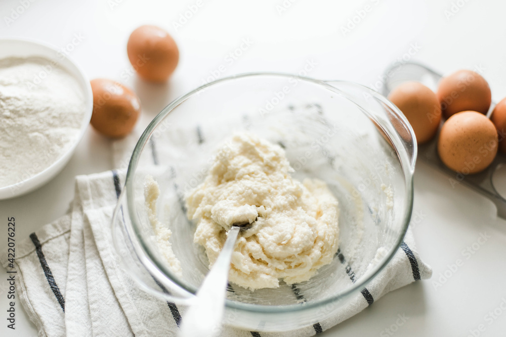 Cooking raw ingredients on white table, making cake. Cooking raw ingredients on white table, making cake.